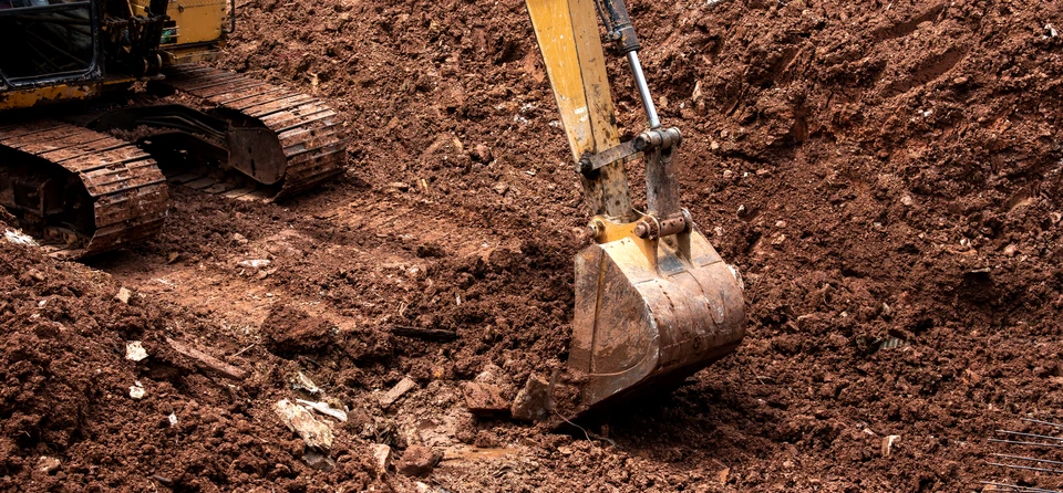 Chantier de terrassement en ext&eacute;rieur avec pelleteuse hydraulique sur chenilles en action